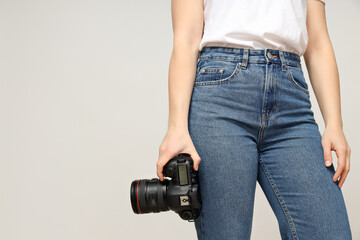 The photographer's camera in the hands, in the photo studio.