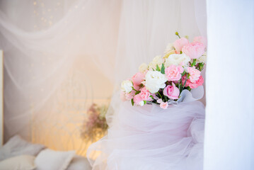 A stunning and beautiful display of pastelcolored flowers elegantly wrapped in tulle, perfect for any events