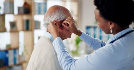 Doctor, senior man and help with hearing aid, healthcare and consultation in modern office. Patient, medical device and professional with technology, listening and test earpiece with wellness or exam