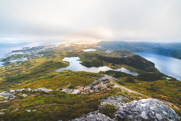 Sun Cutting From Behind A Ridge In Low Clouds