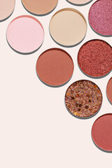 Eyeshadow palette, mix of matte and shimmer shades in pink, nude, red, brown hues. Minimal view pattern for beauty, makeup, cosmetics themes, Vivid colored swatches eyeshade refills round shape