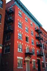 Obraz premium Red brick building with fire escapes