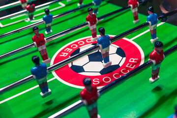 table football game on field, green and red, table game for 2 or more people, players in the stadium