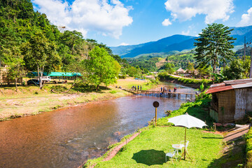 Scenic Rural Landscape in Thailand Surrounded by a River, Mountains, and a Beautiful Sky
