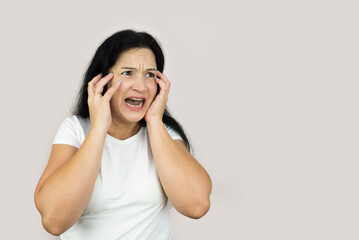 Lifestyle image of a young woman who is shocked and anxious