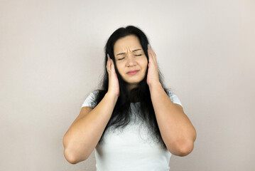 young woman, girl with headache or migraine, suffering from dizziness, holding head with hands, health