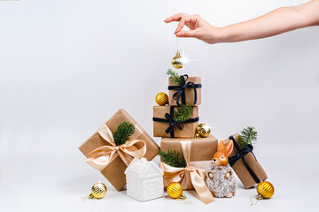 A women decorates a Christmas tree.  Space for text. winter holidays and people concept. Decorating Christmas tree, holding Christmas toy in a hand. Holiday, Christmas and New Year family celebration