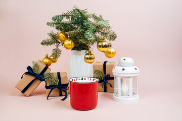 Christmas gifts in craft paper with a blue bow. Christmas tree with golden balls. Top view. Eco style. Mug with cocoa and marshmallow