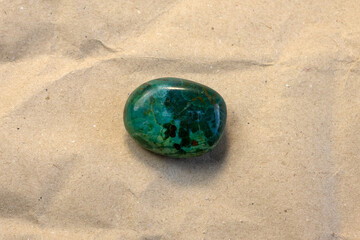 Natural chrysocolla gemstone on craft paper textured background