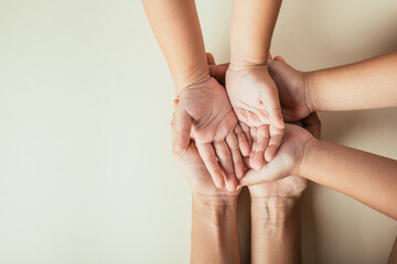 Fototapeta premium Top view of parents and kid holding empty hands together isolated. Symbolizing Family Day togetherness support and generational bonds.