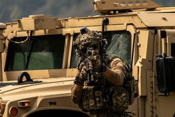 A group of military men in combat gear patrol in the middle of a desert and tropical jungle. Soldiers in full combat gear in dry weather conditions assemble and march on a mission.
