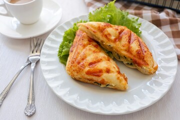 Homemade sandwich in white plate with fork on white background, coffee break