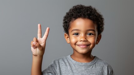 A black kid in a gray shirt with a Peace hand sign.