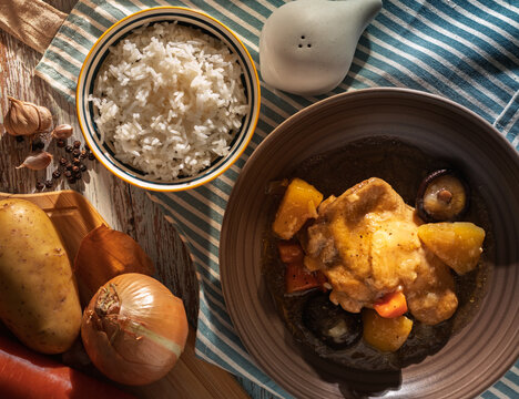 Homestyle chicken stew with potatoes and vegetables served with steamed jasmine rice