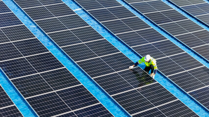 Worker Technicians are working to construct solar panels system on roof. Installing solar...