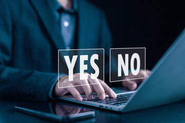 using a laptop showing letters of yes and no. concept decide to choose vote. yes or no decisions, and business options for difficult situations in dilemma. true and false symbols agreeing