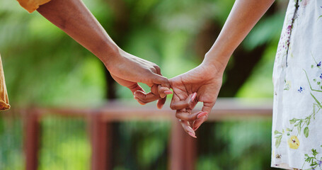 Holding hands, couple and outdoor with pinky promise for commitment, loyalty and trust together....