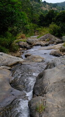 Clear River Flowing Between Rocks in a Scenic Landscape