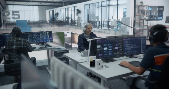 Group of Diverse Young Programmers Working Behind Desks, Using Computers to Write Software Code, Creating Complex Algorithms, Visualizing Big Digital Data Sets for AI Computing Project