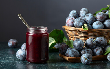 Ripe plums with jam on the kitchen table.
