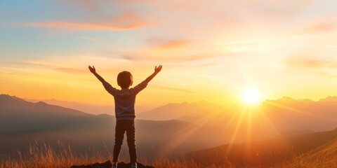 A child stands on a mountain peak, arms raised in joy, embracing the beautiful sunset and the endless possibilities ahead.