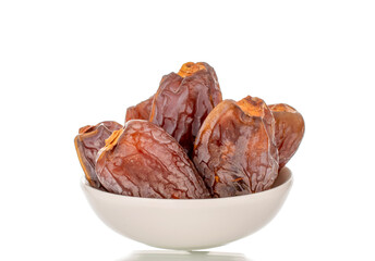 Dried sweet dates with homemade dishes isolated on white background, close-up.