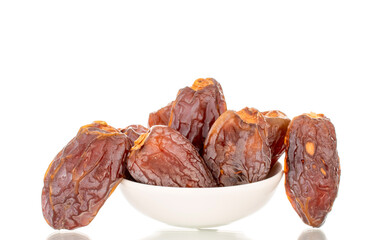 Dried sweet dates with homemade dishes isolated on white background, close-up.