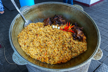 A large pot of food with rice and meat in it