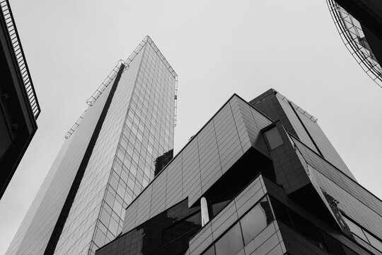 Low angle view of skyscraper buildings against blue sky