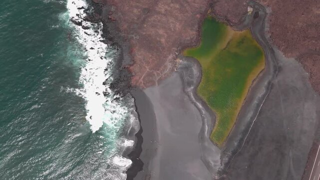 Stunning aerial view of rugged coastline and lush green area along the shore