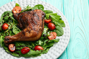 Grilled chicken legs with tomatoes and salad . Top view