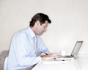 Business, coffee and laptop with mature man in office for administration, reporting or research. Computer, investment and stock market with professional broker in workplace for banking or trading