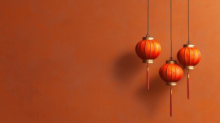 The concept of a minimal background with Chinese lanterns. Three vibrant red lanterns hang against a warm, textured orange wall, symbolizing celebration.