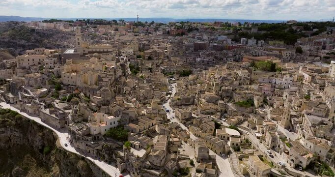 Dense City Over Rocky Outcrop In Matera, Basilicata In Southern Italy. Aerial Pullback Shot