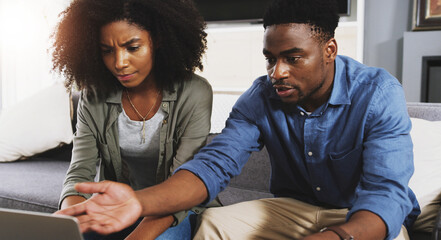 Black couple, laptop and debt with stress for argument, financial crisis or disagreement on sofa at...