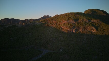 Serene Mountain Landscape at Sunrise with Rolling Hills and Sky.