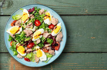 Canned Tuna salad with eggs and tomatoes photography . Top view
