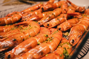 A plate of shrimp with a green sauce