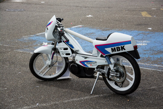Mulhouse - France - 10 November 2024 - profile view of white tuning MBK motorcycle parked in the street