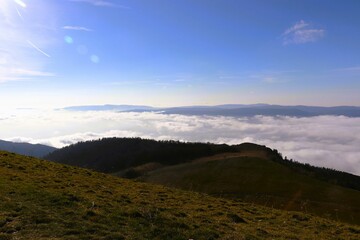Rolling hills above a sea of clouds