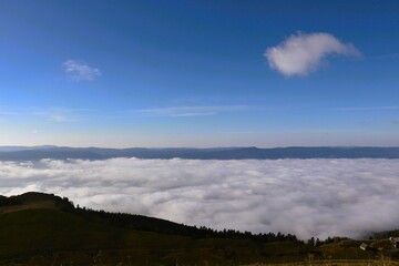 Serene mountain landscape with clouds and blue sky