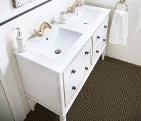 Luxury white marble bathroom interior with a white bathtub, a seating bench, ceramic basins, a small wooden table for toiletries, and one ornamental slider. Vintage decor. Mockup. 3D Rendering