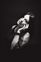 Sensual portrait of a woman with dark hair, done in a low key style.