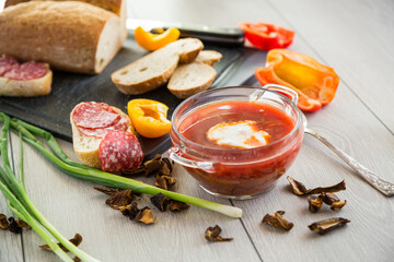 Lenten borscht with dried mushrooms and vegetables, on a light wooden table