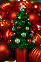 Christmas tree with red and gold baubles on a blurred background