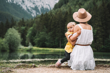 Fototapeta premium Mother and daughter together on nature. Family outdoor.