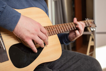 Hand Playing Acoustic Guitar Close-Up, musician practicing chords on fretboard, performer strumming...
