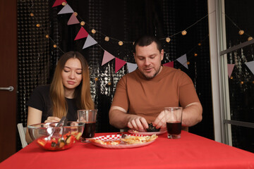 Couple Dining Together at Festive Table, celebrating anniversary with people at home, festive event with decor and happiness