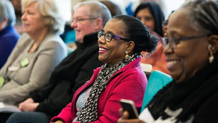 Diverse group of senior adults attending seminar, learning and engagement in community setting. Smiling participants, positive interaction, and focus on education and social connection indoors