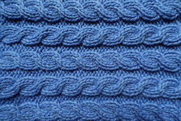 handmade blue knitted fabric with cable braids texture